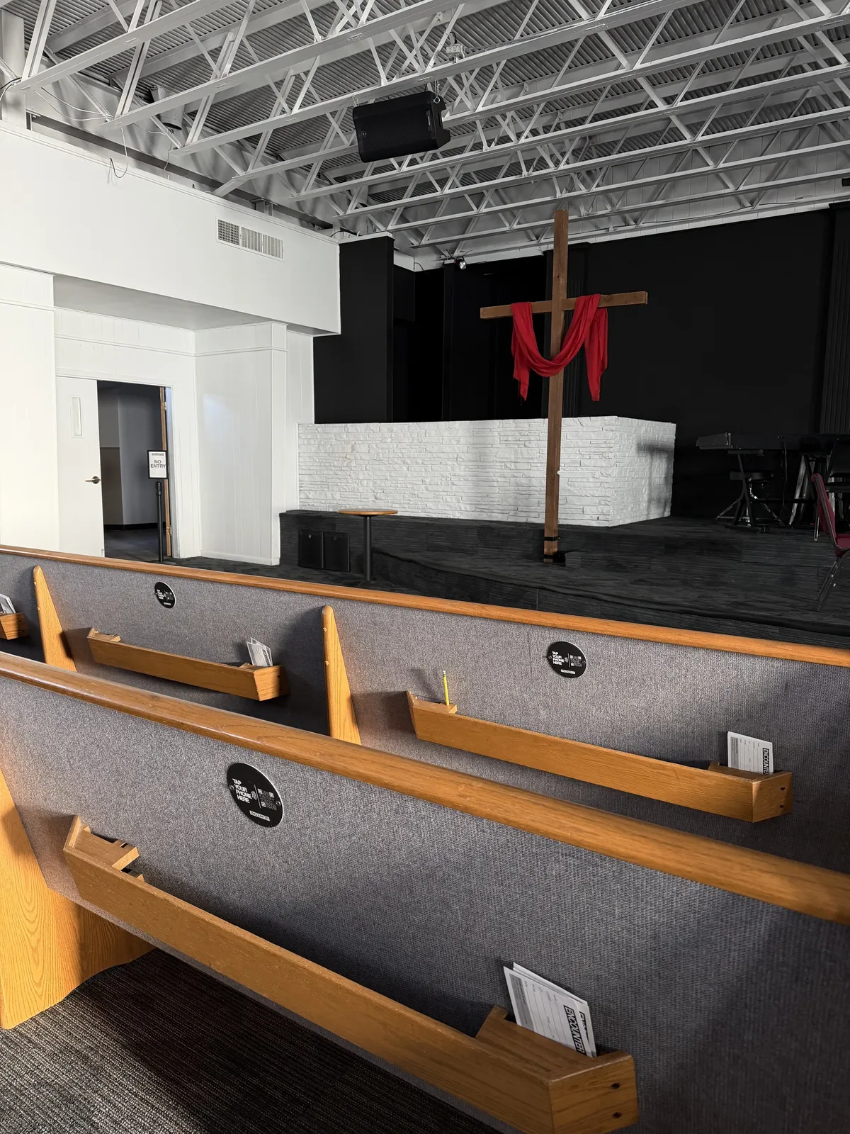 NFC giving plate mounted on a Lutheran church pew back for tap to give