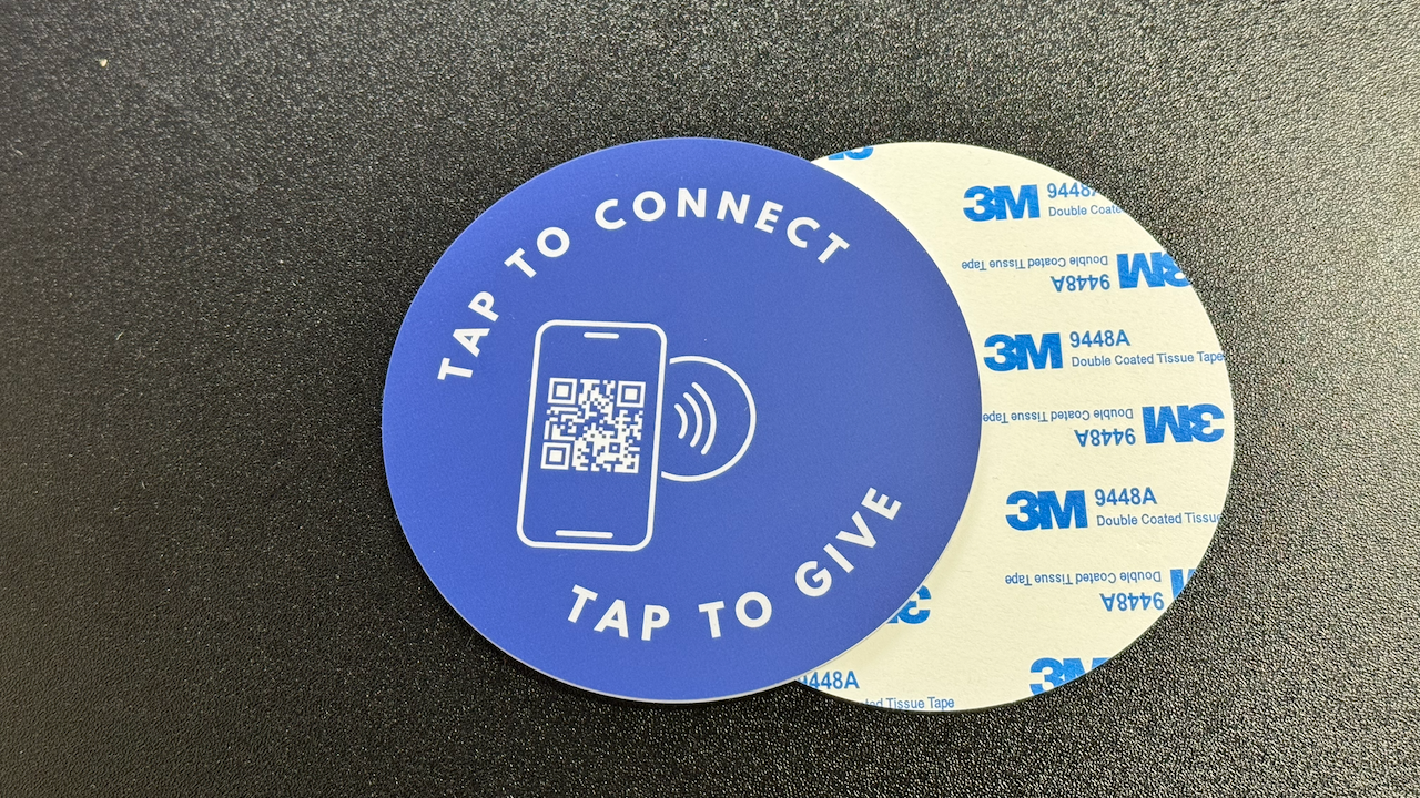 Smartphone tapping an NFC giving plate at a church without needing an app