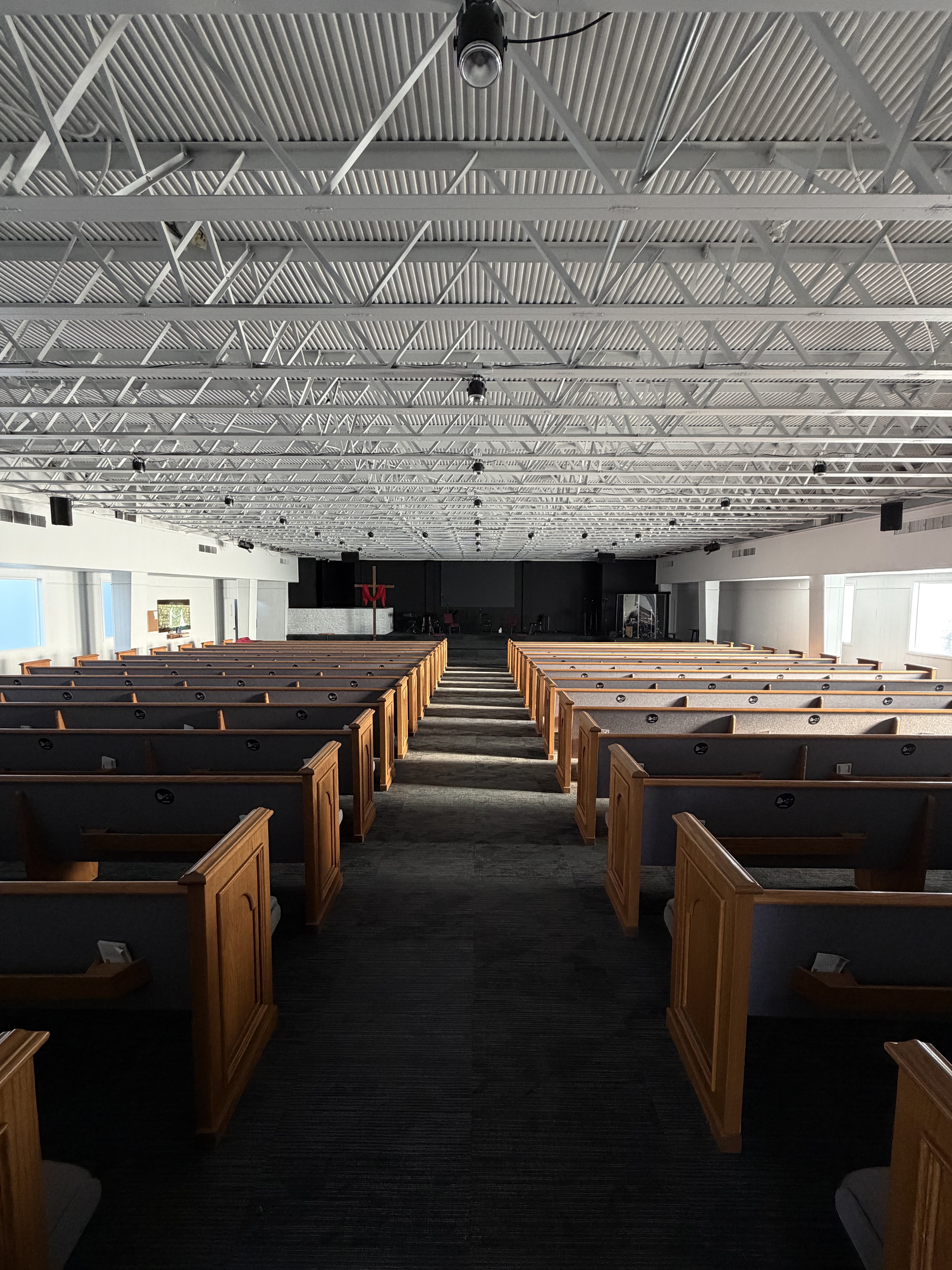 Sunlit church pews ready for a congregation