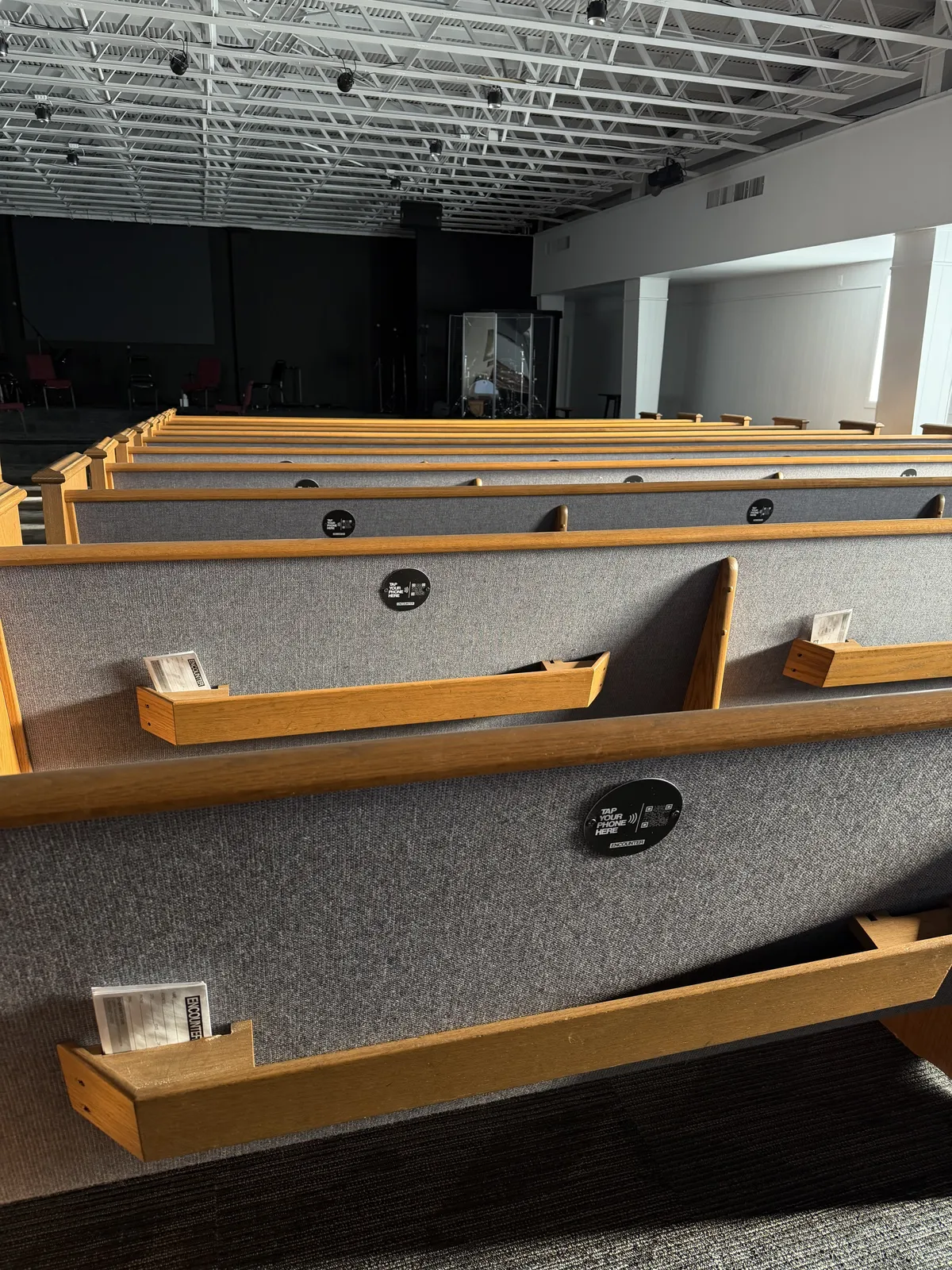Church pews where visitors encounter the offering moment each Sunday