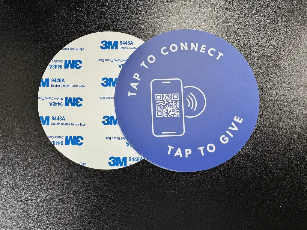Front and back of a Tap.Giving plate: the custom-printed face and the 3M adhesive backing